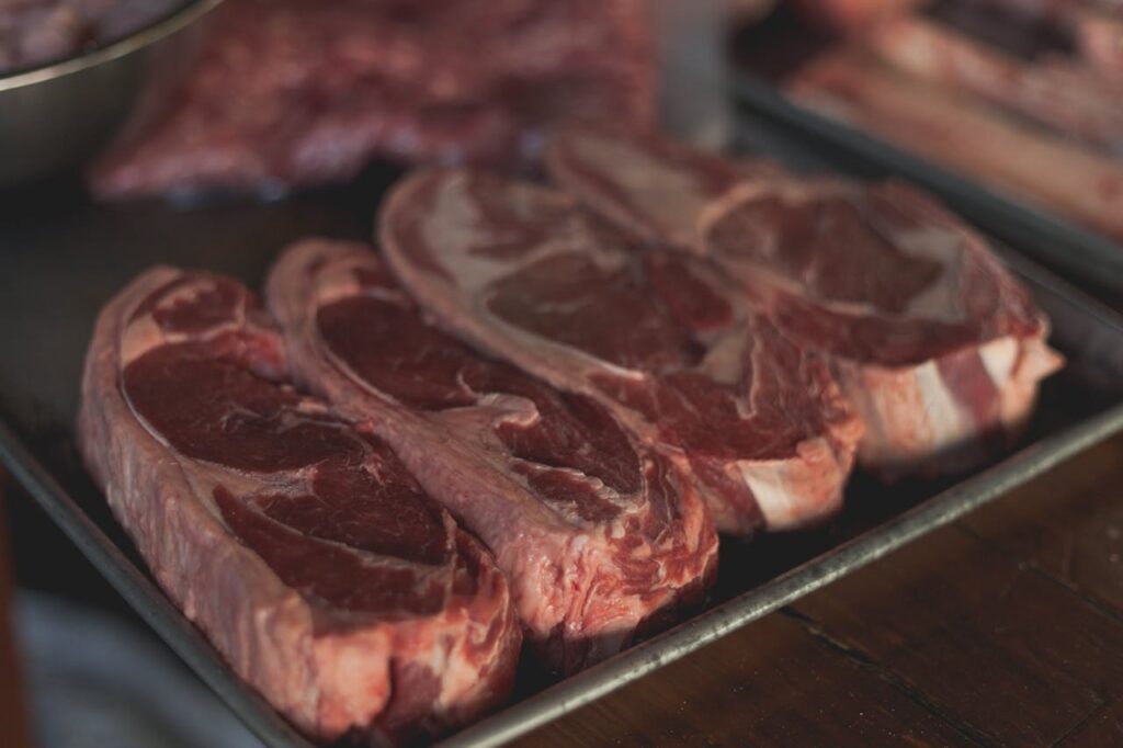 Mastering the First Impression: Your intriguing post title goes here High-quality close-up image of raw steaks ready for cooking on a metal tray.